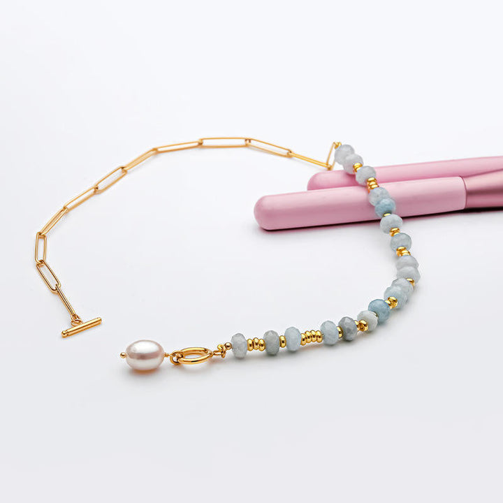 Zoé – Lange goldene Ohrringe mit Perlenanhänger.